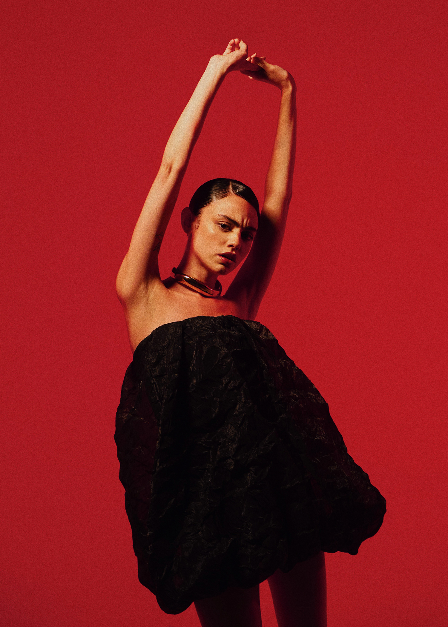 Editorial — red background, gesture